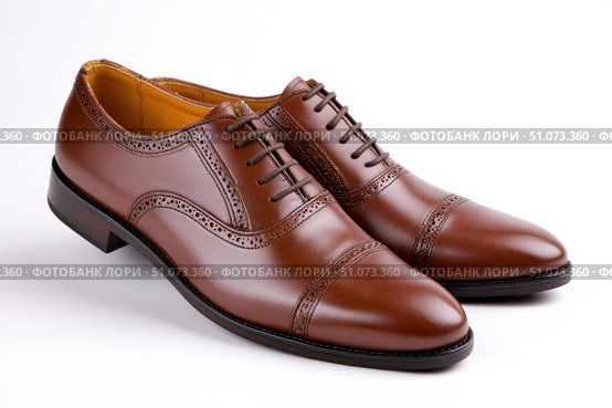 Elegant brown leather brogue shoes resting on white background. Стоковое AI-изображение, AI-художник Юрий Поздников / Фотобанк Лори