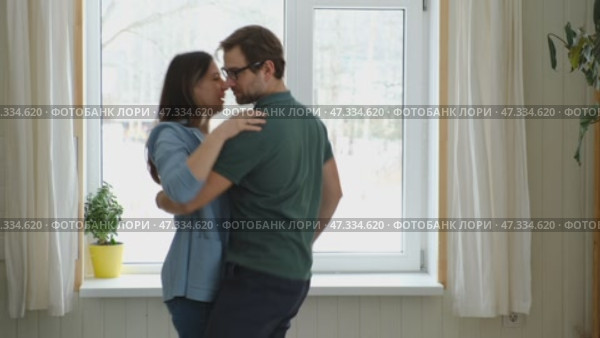 Emotional Dance. Middle-aged Couple Dancing Together Embrace at Home. Mature Couple dancing bonding, smiling and moving to the rhythm in a romantic vibe enjoying their anniversary. Active relationship. Стоковое видео, видеограф Марина Демидюк / Фотобанк Лори