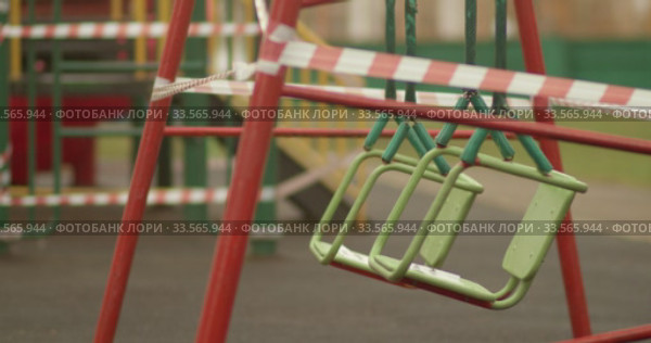 Empty playgrounds covered with a protective tape during quarantine of coronavirus, covid-19 virus. Стоковое видео, видеограф Aleksandr Lutcenko / Фотобанк Лори