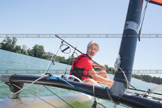 enjoying extreme sailing with racing sailboat. Стоковое фото, агентство Ingram Publishing / Фотобанк Лори