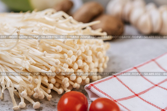 Enokitake, tomato, and red white cloth. Selective focus. Стоковое фото, агентство Ingram Publishing / Фотобанк Лори