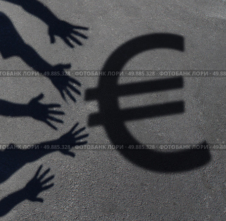 Euro demand as the cast shadow of a group of hands reaching out to grab the European currency symbol as a financial and business concept or money financing issues and economic symbol. Стоковое фото, агентство Ingram Publishing / Фотобанк Лори