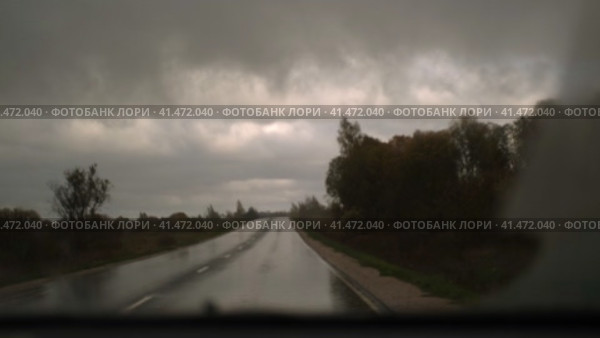 Extreme Driving during heavy downpour storm. Selective focus. POV of car windscreen. Dangerous wet asphalt road trip. Bad visibility. Moving windshield wiper vehicle. Traffic at Rainfall. Travel blog. Стоковое видео, видеограф Марина Демидюк / Фотобанк Лори
