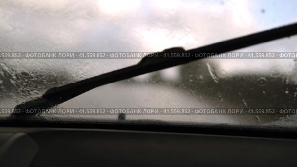 Extreme Driving during heavy downpour storm. Selective focus. POV of car windscreen. Dangerous wet asphalt road trip. Bad visibility. Moving windshield wiper vehicle. Traffic at Rainfall. Travel blog. Стоковое видео, видеограф Марина Демидюк / Фотобанк Лори