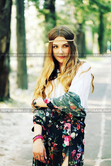 Fashion portrait of beautiful hippie young woman wearing boho chic clothes and summer hat outdoors. Soft warm vintage color tone. Artsy bohemian style. Стоковое фото, агентство Ingram Publishing / Фотобанк Лори