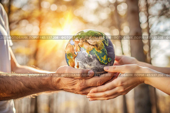 Female and male hands hold a small model of the Earth. Revival. Caring for the planet, ecological awareness and the unity of people in nature conservation. Стоковое AI-изображение, AI-художник Photojuli / Фотобанк Лори