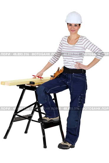 female carpenter and workbench isolated on white. Стоковое фото, агентство Ingram Publishing / Фотобанк Лори