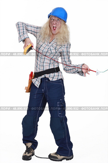 Female electrician getting a shock. Стоковое фото, агентство Ingram Publishing / Фотобанк Лори