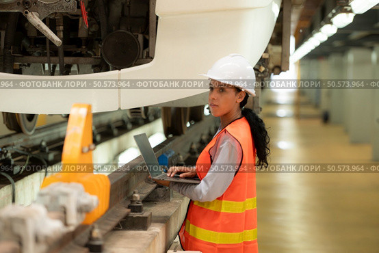 Female engineers work together in an electric repair station. Inspect head of electric trains that come in for repairs in the skytrain repair station. Стоковое фото, агентство Ingram Publishing / Фотобанк Лори