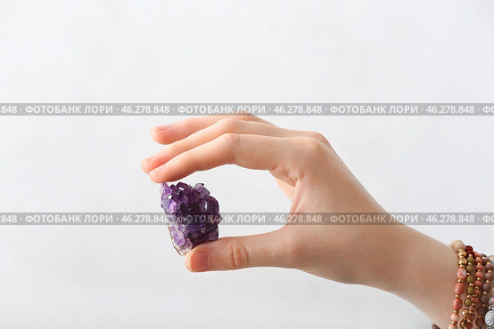 Female hand with beautiful amethyst on light background. Стоковое фото, фотограф Pixel_shot / Фотобанк Лори