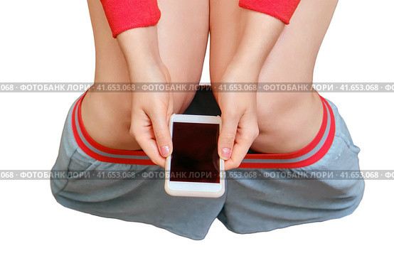 Female legs on the background of the remnants of toilet paper and a phone in her hands, isolated on a white background. Concept stomach disease, poisoning and diarrhea problems. Стоковое фото, фотограф Андрей Журавлев / Фотобанк Лори