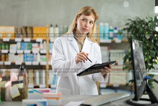 Female pharmacist working on tablet in pharmacy. Стоковое фото, фотограф Яков Филимонов / Фотобанк Лори