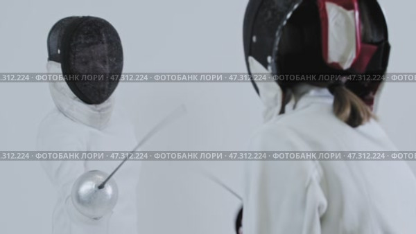 Fencing - two young women fencers in white suits training the fight. Стоковое видео, видеограф Константин Шишкин / Фотобанк Лори