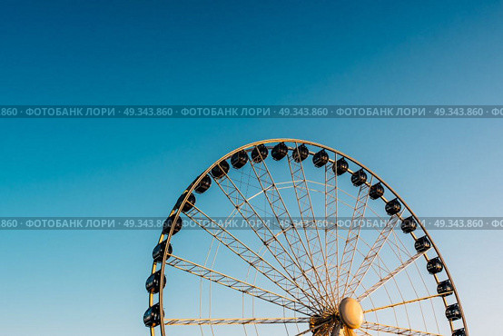 Ferris wheel against the blue sky in the port city Gdynia Poland. Стоковое фото, агентство Ingram Publishing / Фотобанк Лори