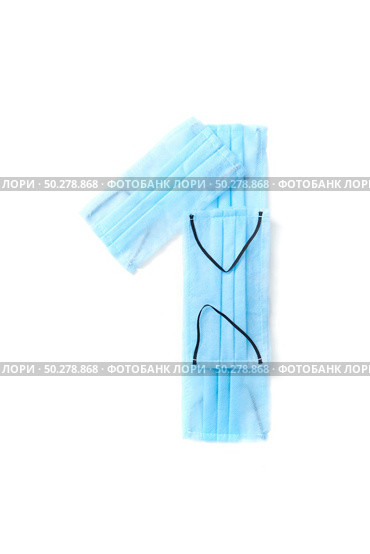 Figure 1, one handmade from medical antibacterial protective blue face masks on a white background, copy space. Creative typeface for making up new numerical information.. Number one made from protective medical masks on a white background. Стоковое фото, агентство Ingram Publishing / Фотобанк Лори