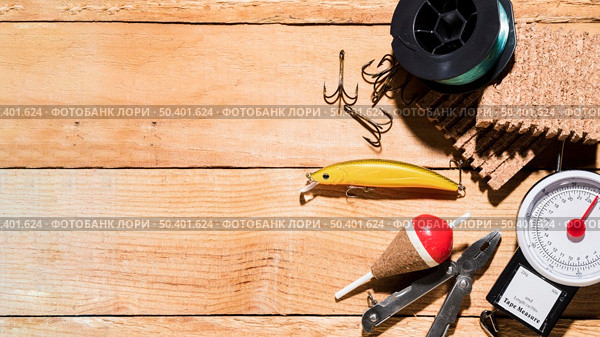 fishing reel fishing lure fishing float plier corkboard weighing scale table. Стоковое фото, агентство Ingram Publishing / Фотобанк Лори