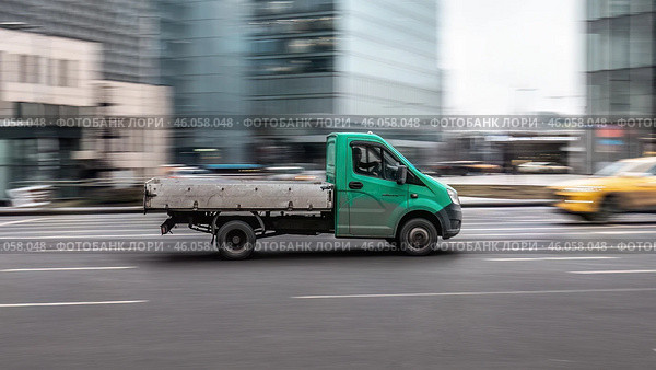 Flatbed truck Gazelle NEXT in motion on city streets. Редакционное фото, фотограф Константин Григорьев / Фотобанк Лори