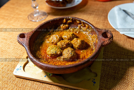 Flavorful kefta tagine cooked in rich tomato sauce, lamb meatballs, traditional moroccan delight. Стоковое фото, фотограф Евгений Ткачёв / Фотобанк Лори