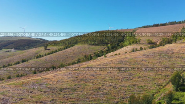 Flying Above Green Mountains Toward Giant Wind Turbines On Hill. Aerial View. Стоковое видео, видеограф Кирилл Трифонов / Фотобанк Лори