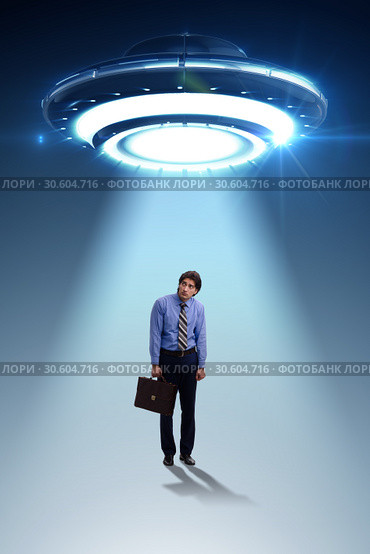 Flying saucer abducting young businessman. Стоковое фото, фотограф Elnur / Фотобанк Лори