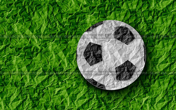 Football Soccer Background and sport as a grass sports field with a european game football on a green paper turf . Стоковое фото, агентство Ingram Publishing / Фотобанк Лори