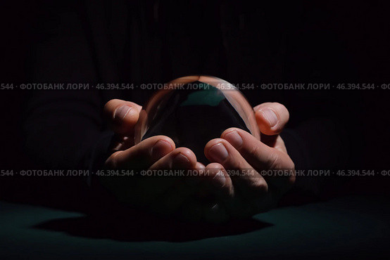 Fortune teller with crystal ball on dark background. Стоковое фото, фотограф Pixel_shot / Фотобанк Лори