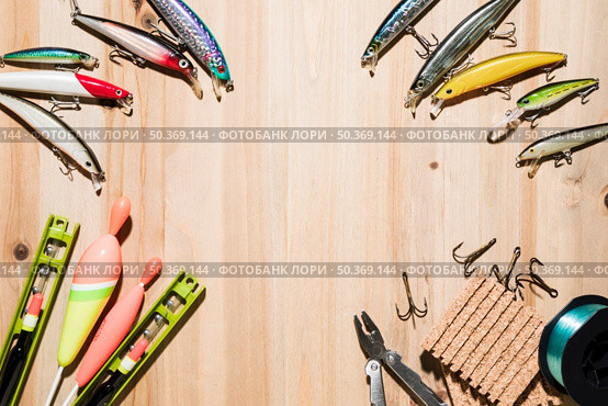 frame made with fishing lure fishing float plier hooks wooden backdrop. Стоковое фото, агентство Ingram Publishing / Фотобанк Лори