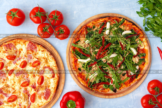 Fresh pizza with herbs and sun dried tomatoes on gray table. Стоковое фото, фотограф Сергей Толмачёв / Фотобанк Лори