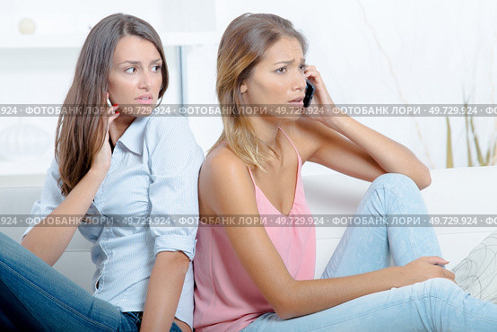 friend supporting beautiful girl sad on the phone. Стоковое фото, агентство Ingram Publishing / Фотобанк Лори