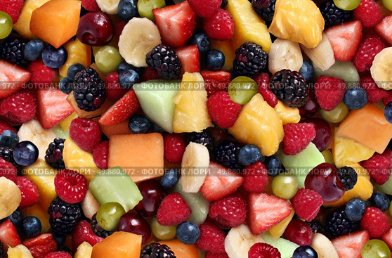 Fruit salad background featuring fresh berries and cut fruits as as blueberry blackberry green strawberries melon cantaloup rasperry pineapple banana and grapes as a symbol of healthy lifestyle eating and living well through natural nutrition. . Стоковое фото, агентство Ingram Publishing / Фотобанк Лори