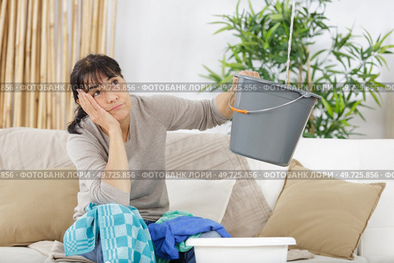 frustrated woman during leaking roof or pipe burst. Стоковое фото, агентство Ingram Publishing / Фотобанк Лори