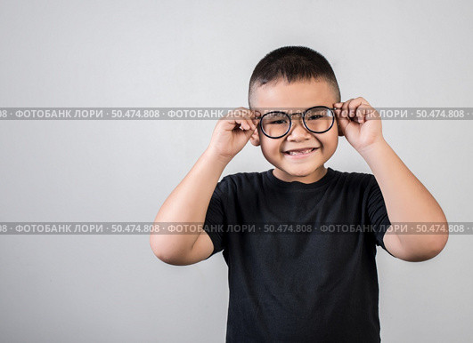 Funny boy genius wearing glasses in studio shot. Стоковое фото, агентство Ingram Publishing / Фотобанк Лори