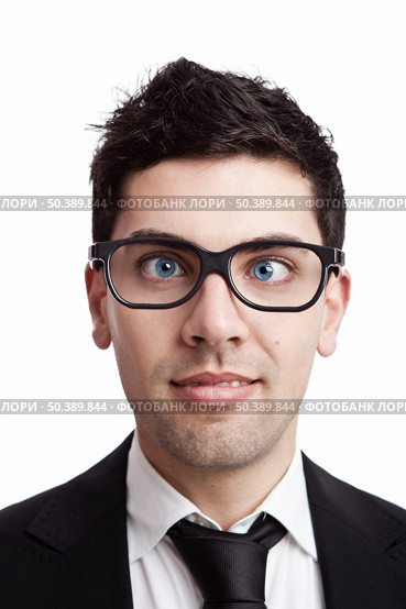 Funny portrait of a young businessman with crooked eyes wearing nerd glasses. Стоковое фото, агентство Ingram Publishing / Фотобанк Лори