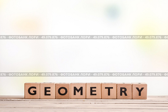 Geometry lessons sign on a classroom table. Стоковое фото, агентство Ingram Publishing / Фотобанк Лори