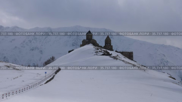 Gergeti Trinity Church against the mountain Kazbek. Georgia. Стоковое видео, видеограф Яков Филимонов / Фотобанк Лори