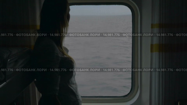 Girl opening blind in cabin to look at the sea. Стоковое видео, видеограф Данил Руденко / Фотобанк Лори