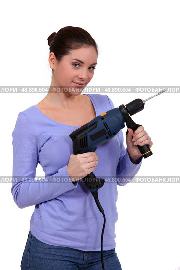 girl posing with drill. Стоковое фото, агентство Ingram Publishing / Фотобанк Лори