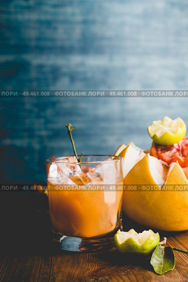 Glass of citrus juice mix on table at dark wall background. Vitamin C drink . Healthy lifestyle. Стоковое фото, агентство Ingram Publishing / Фотобанк Лори