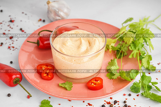 Glass of tasty chipotle sauce and spices on light background. Стоковое фото, фотограф Pixel_shot / Фотобанк Лори