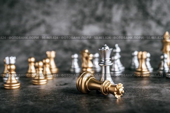 Gold and Silver Chess on chess board game for business metaphor leadership concept . Стоковое фото, агентство Ingram Publishing / Фотобанк Лори