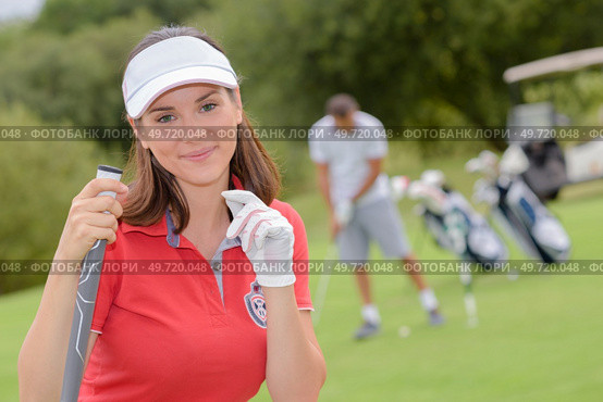 golfers women who are golfing view from the back. Стоковое фото, агентство Ingram Publishing / Фотобанк Лори