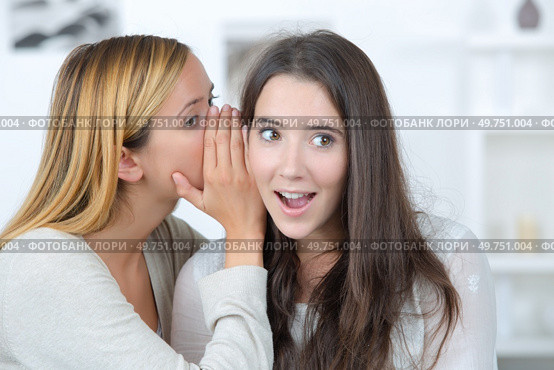 gossip girl tells a secret to her friend. Стоковое фото, агентство Ingram Publishing / Фотобанк Лори