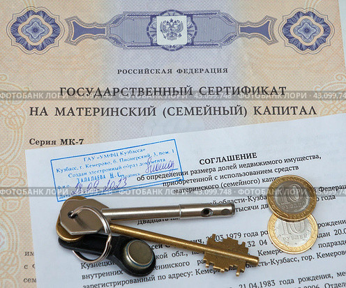 Государственный сертификат материнский (семейный) капитал, соглашение об определении размера долей недвижимого имущества, деньги и ключи от дверного замка (2024 год). Редакционное фото, фотограф Цибаев Алексей / Фотобанк Лори