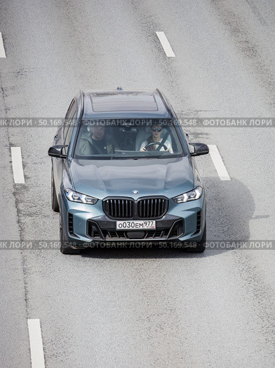 Grayish blue BMW X5 on city highway. Front above view of luxury SUV in motion. Редакционное фото, фотограф Константин Григорьев / Фотобанк Лори