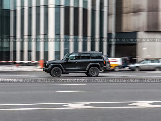 Great wall tank 300 car is driving in the cityscape. Side view of black chinese SUV in motion. Редакционное фото, фотограф Константин Григорьев / Фотобанк Лори