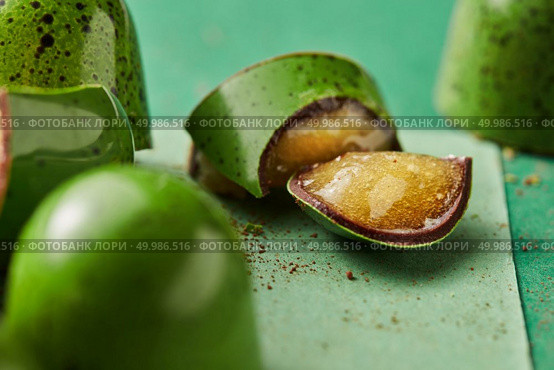 green candy cane cut on a green background. green chocolate candy with jelly. Стоковое фото, агентство Ingram Publishing / Фотобанк Лори
