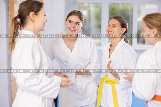 Group of young women are talking after successful and tedious karate workout. Стоковое фото, фотограф Яков Филимонов / Фотобанк Лори