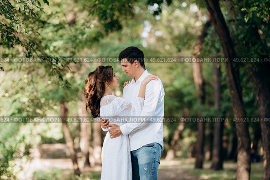 guy and a girl walk along the paths of a forest park between tall trees. Стоковое фото, агентство Ingram Publishing / Фотобанк Лори