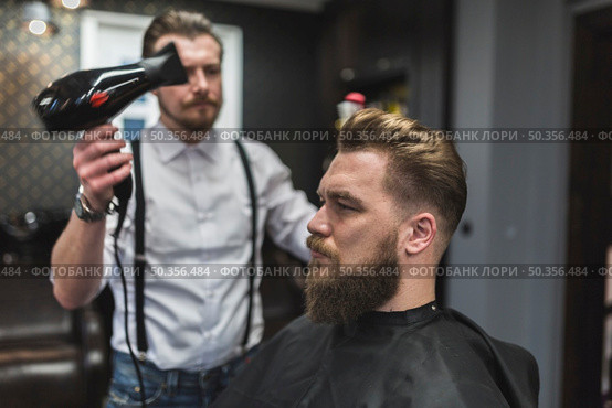 hairdresser using drier hair client. Стоковое фото, агентство Ingram Publishing / Фотобанк Лори