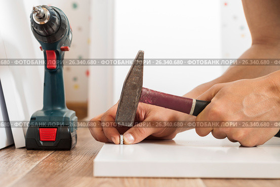 Hand assembly of furniture. Стоковое фото, фотограф Myroslav Kuchynskyi / Фотобанк Лори
